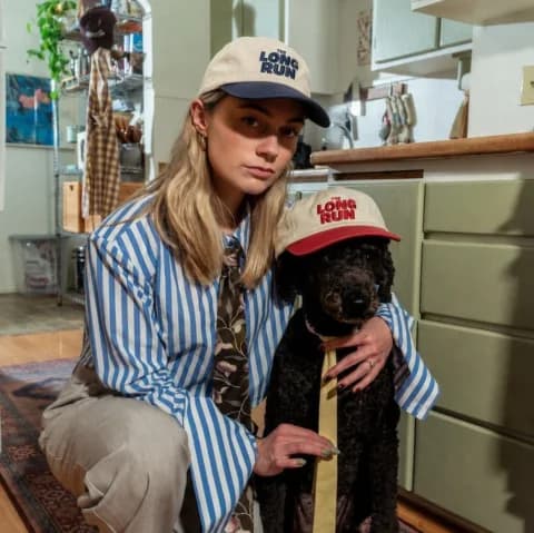 Woman and dog in Long Run caps